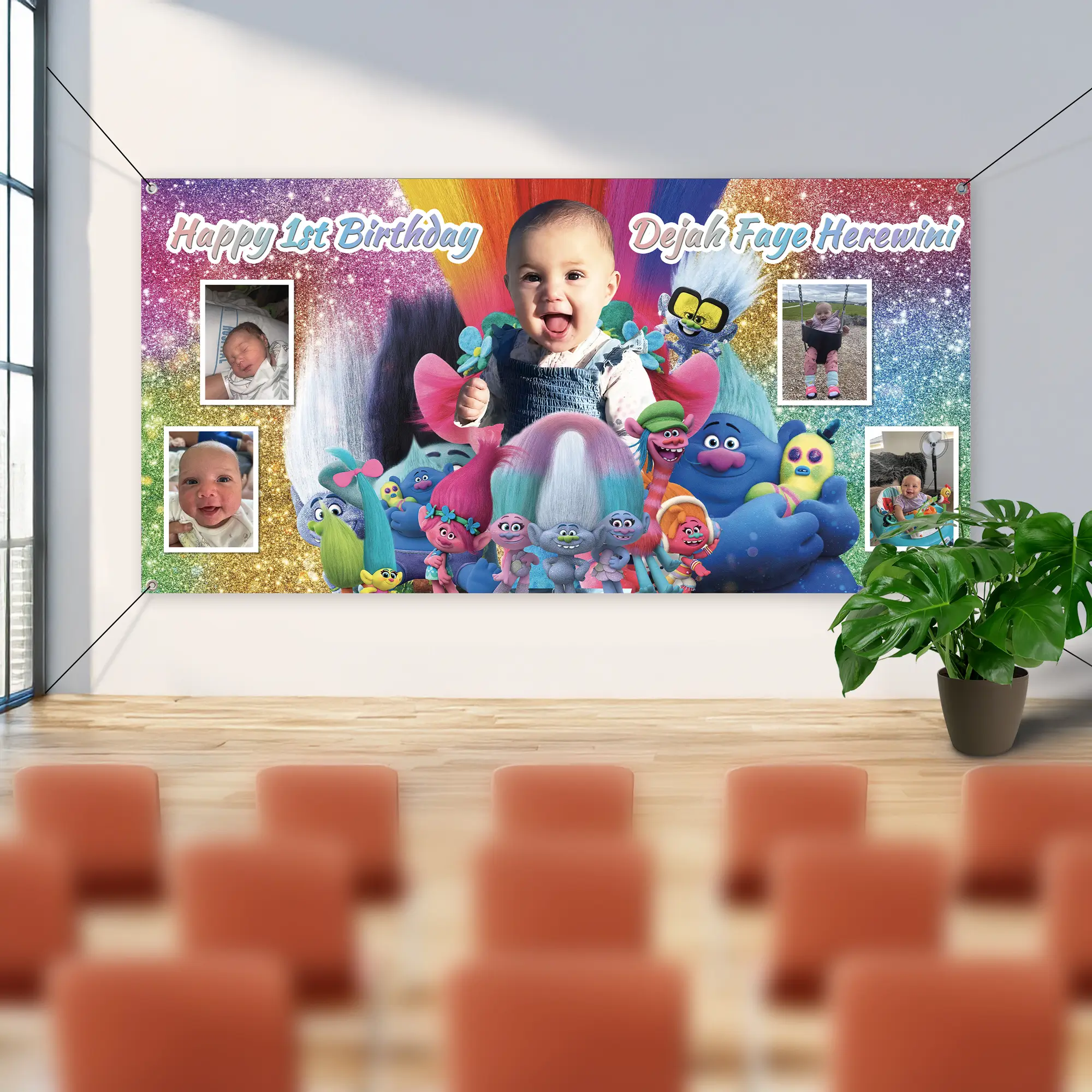 A wide personalised first birthday wall banner hung by its corner eyelets